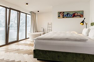 Bedroom with open bathroom and view of the Traunstein